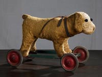 Dog on Wheels Plush toy and metal wheel framework c. 20th century