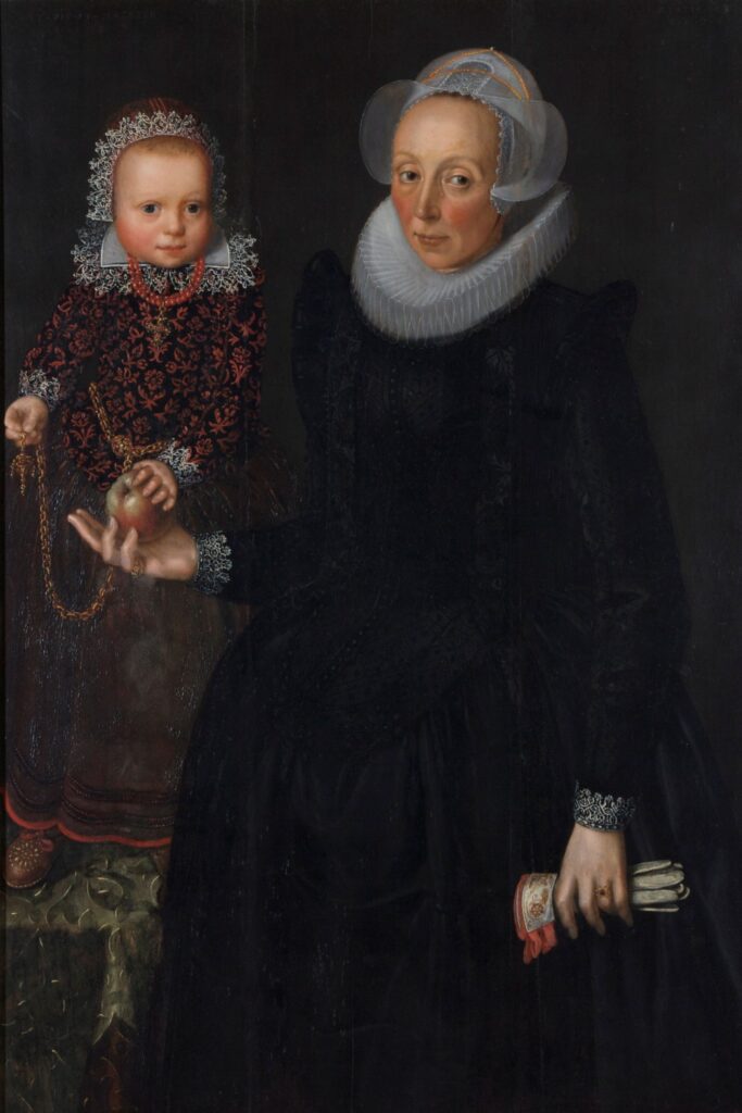 Attributed to Wybrand de Geest (Dutch, 1592-ca. 1661), Mother and Child, ca. 1625, oil on panel. Gift of Mr. Nathan Joseph Leigh, 1956.30.
In this charming double portrait of a richly dressed mother and child, a young girl stands on a table, placing her at almost the same height as her mother. The child holds a rattle attached on a chain to her waist and wears a necklace of coral beads, believed to have healing properties and to ward off disease.
An inscription on the upper right and left of this painting indicates that the infant was 19 months old in 1623 and the mother at right was 43 years old in 1625. This discrepancy in dates suggests the figures were painted at different times, perhaps marking a death.