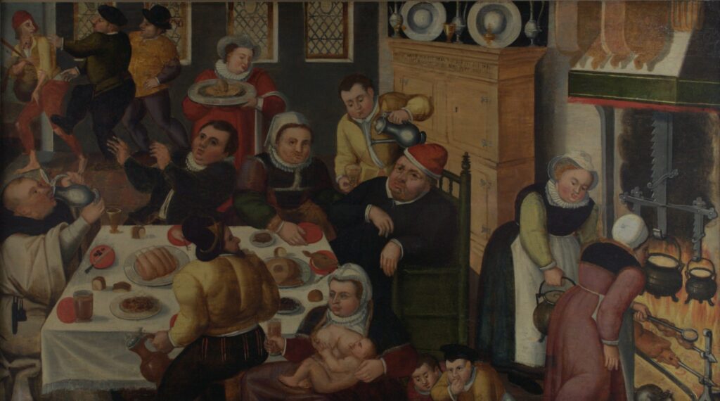 Unknown artist after Peter Bruegel the Elder (Flemish, ca. 1525-1569), The Fat Kitchen, 1600, oil on panel. Gift of Dr. & Mrs. Werner Muensterberger, 1963.11.
In a critique of gluttony and excess, this wry feast scene is loosely modeled after the satirical print The Fat Kitchen, 1563 by Peter Bruegel the Elder. Despite the abundant food on view, the diners do not extend their hospitality to a thin, tattered beggar, who is being pushed out the door. At left a monk is drinking excessively instead of exhibiting temperate, religious behavior. The scene is descriptive as well as prescriptive, offering a sense of what furniture, clothing, and food preparation looked like in 1600 in the Netherlands and Flanders.
Bruegel’s Fat Kitchen was produced as one of a pair of prints, along with The Thin Kitchen, which shows starving peasants fighting for scraps. The extremes of feast and famine remind viewers that fortune can shift, suggesting moderation as the ideal path.